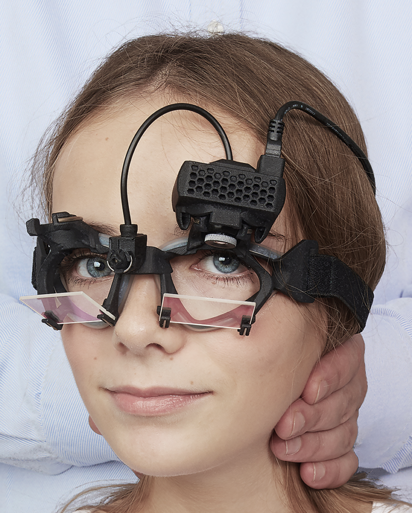 patient wearing eye tracking equipment