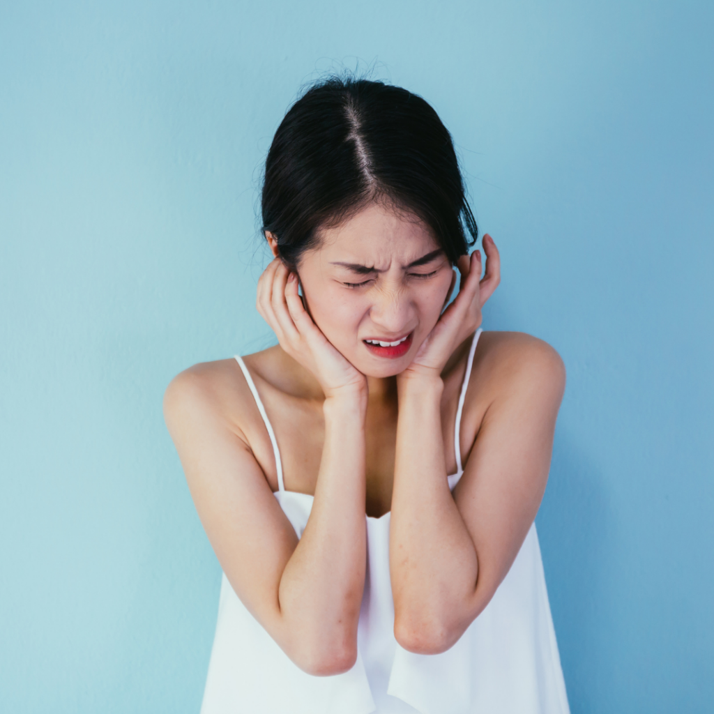 Woman experiencing tinnitus discomfort and seeking tinnitus treatment in Australia
