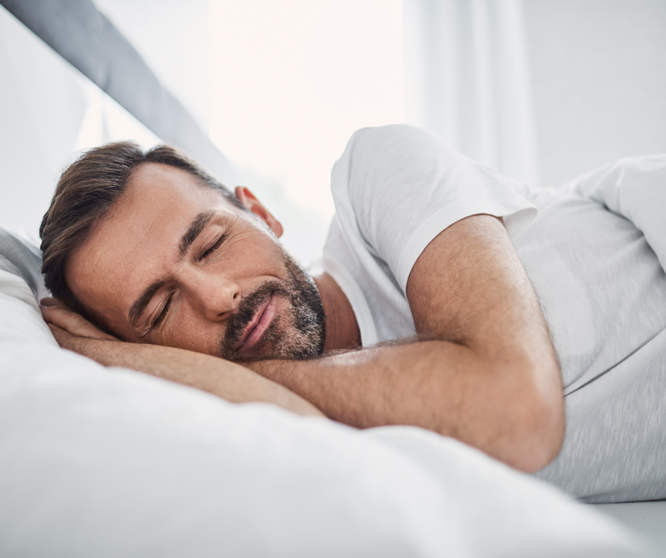 Picture of a man sleeping soundly on his bed with the help of a white noise generator for tinnitus relief in Australia