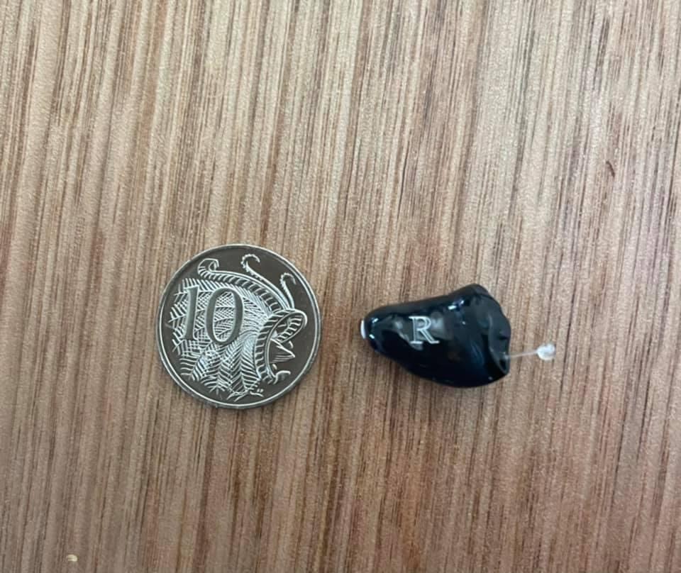 small CIC hearing aid with 10 cent coin