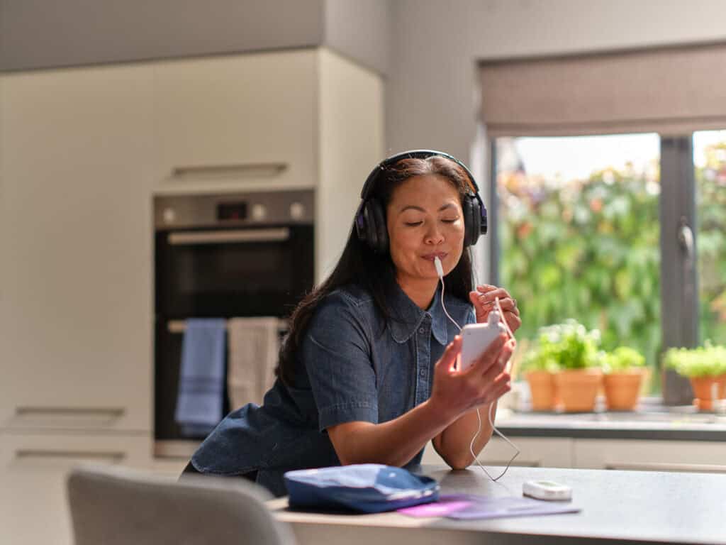Person using personalised sound therapy for tinnitus management