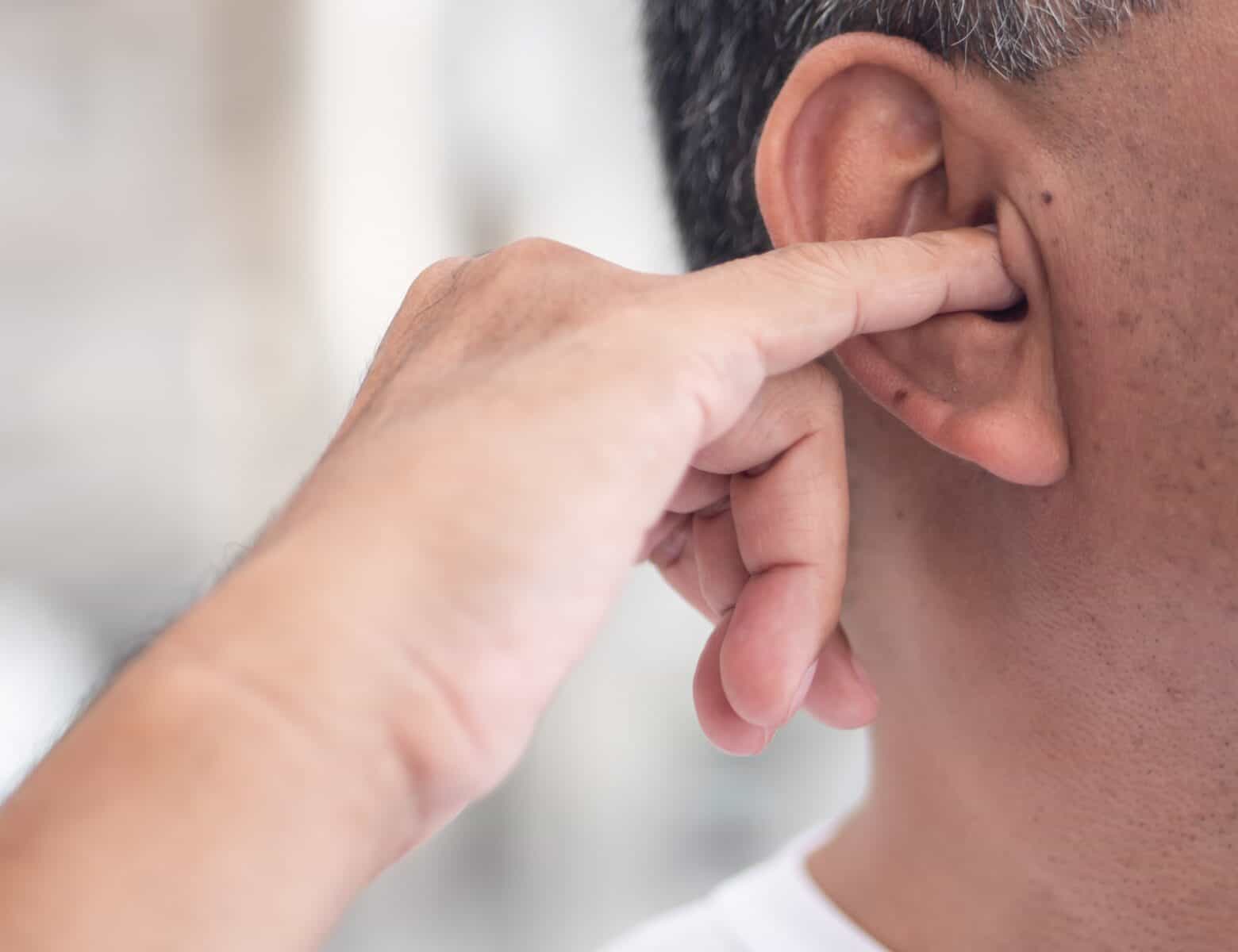Person experiencing a suddenly blocked or muffled ear